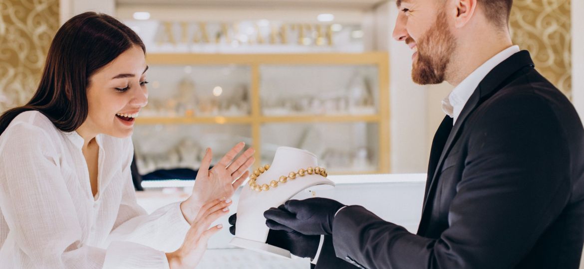 Woman choosing a necklace at jewelry store